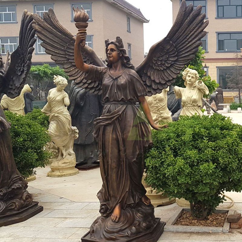 Life-size bronze sculpture of an angel holding a torch