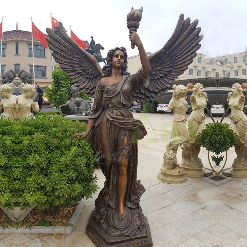 Life-size bronze sculpture of an angel holding a torch