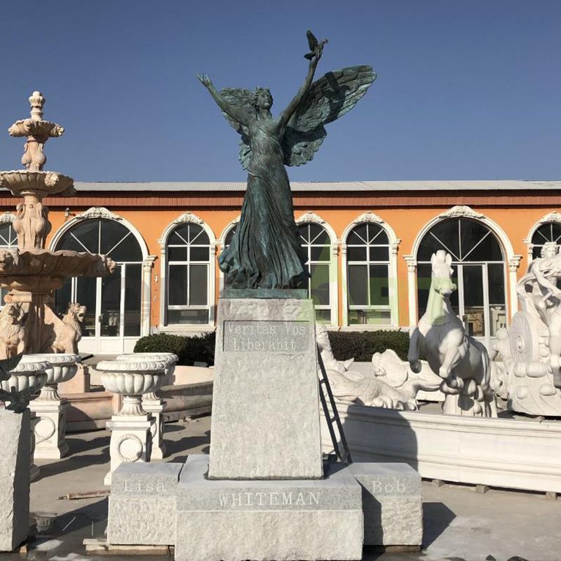 Angel sculptures dancing with doves of peace