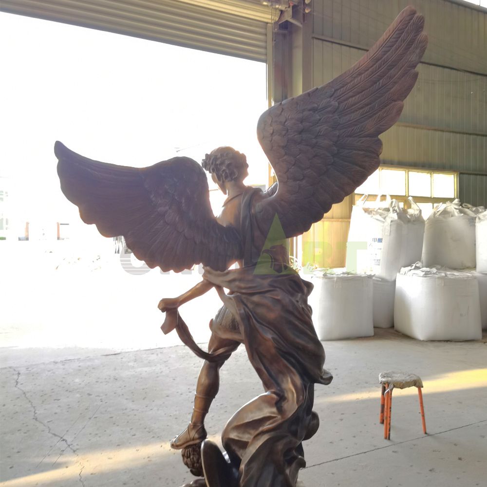 A statue of an angel holding a sword to subdue a demon