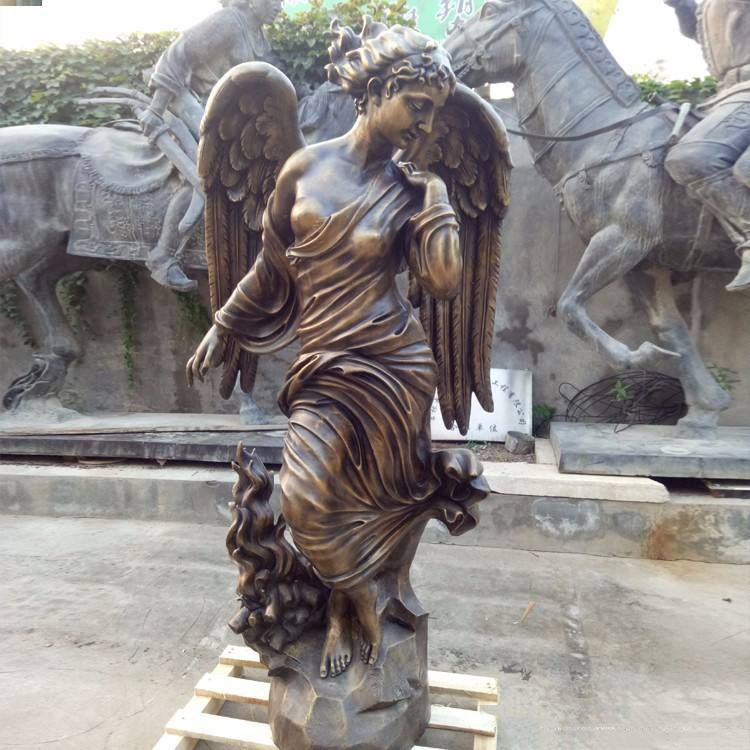 Elegant sculpture of a female angel with her wings closed