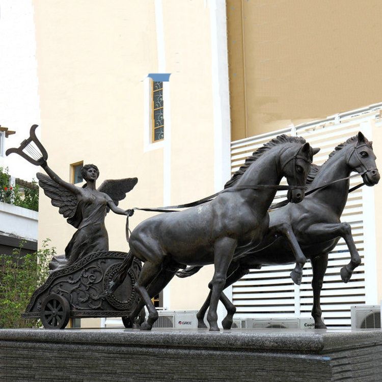 A statue of a heroic angel riding on a horse