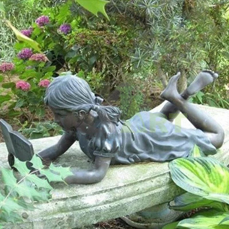 On the stone bench a little girl was climbing to read a book