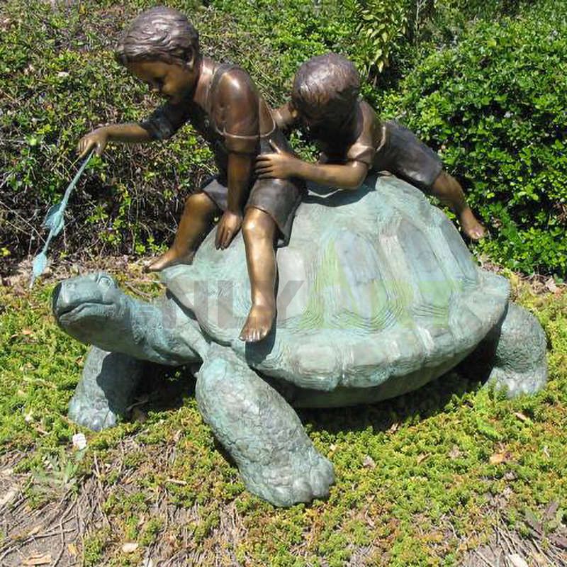 Two children were playing with the turtle on its back