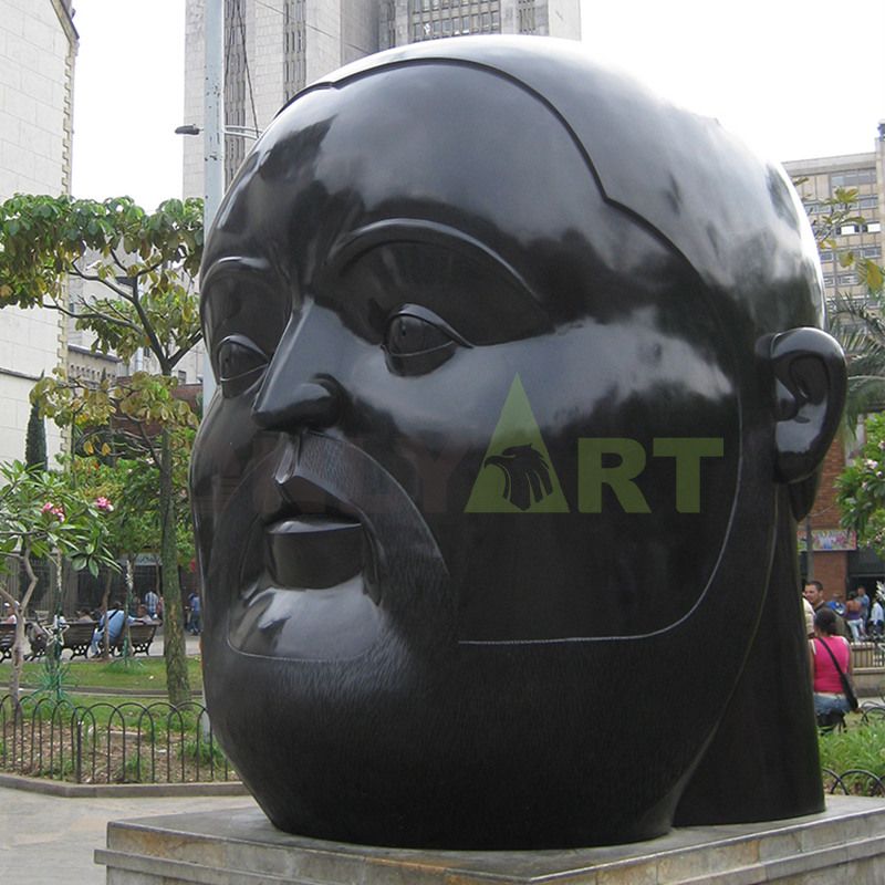 Sculpture of a large black man with a flat head and a fat face