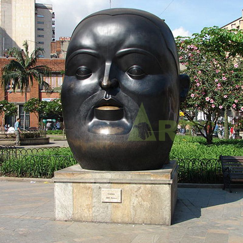 Sculpture of a large black man with a flat head and a fat face