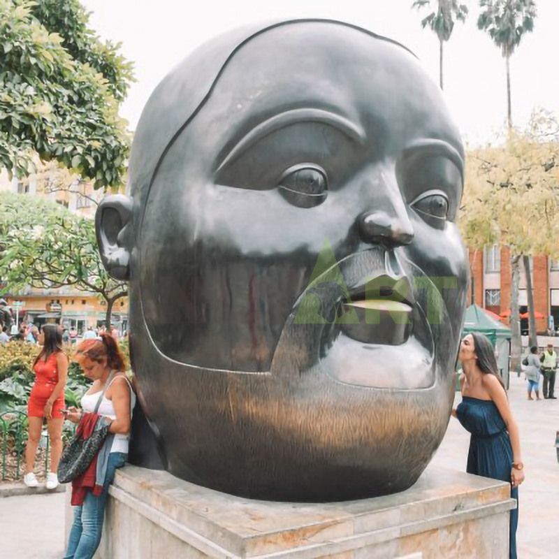 Sculpture of a large black man with a flat head and a fat face