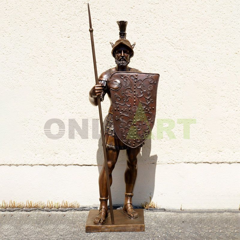 A life-size bronze statue of a Roman warrior carrying a shield and spear