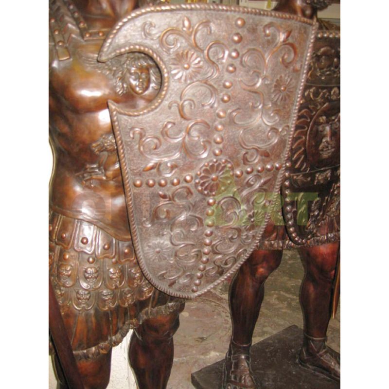 .A Bronze statue of a Spartan helmet holding a shield at the waist