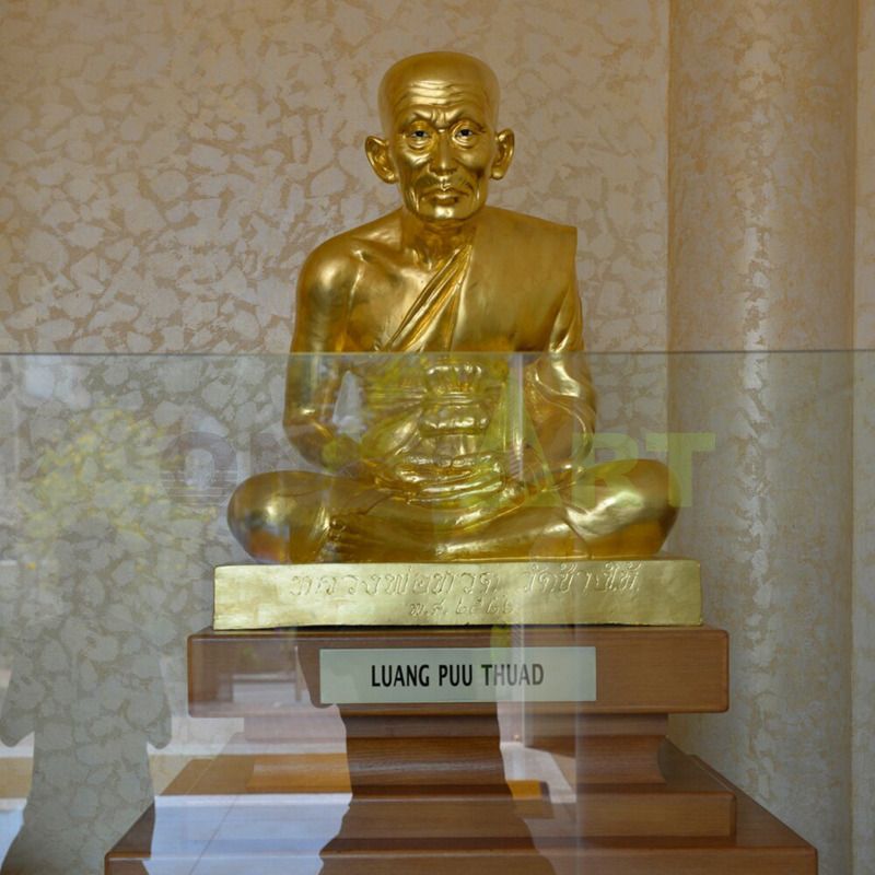 A bronze sculpture of a young Buddhist abbot