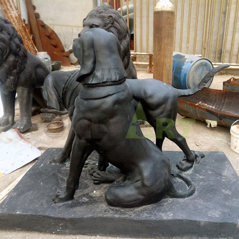 . Sculpture of two dogs on a leash in a park