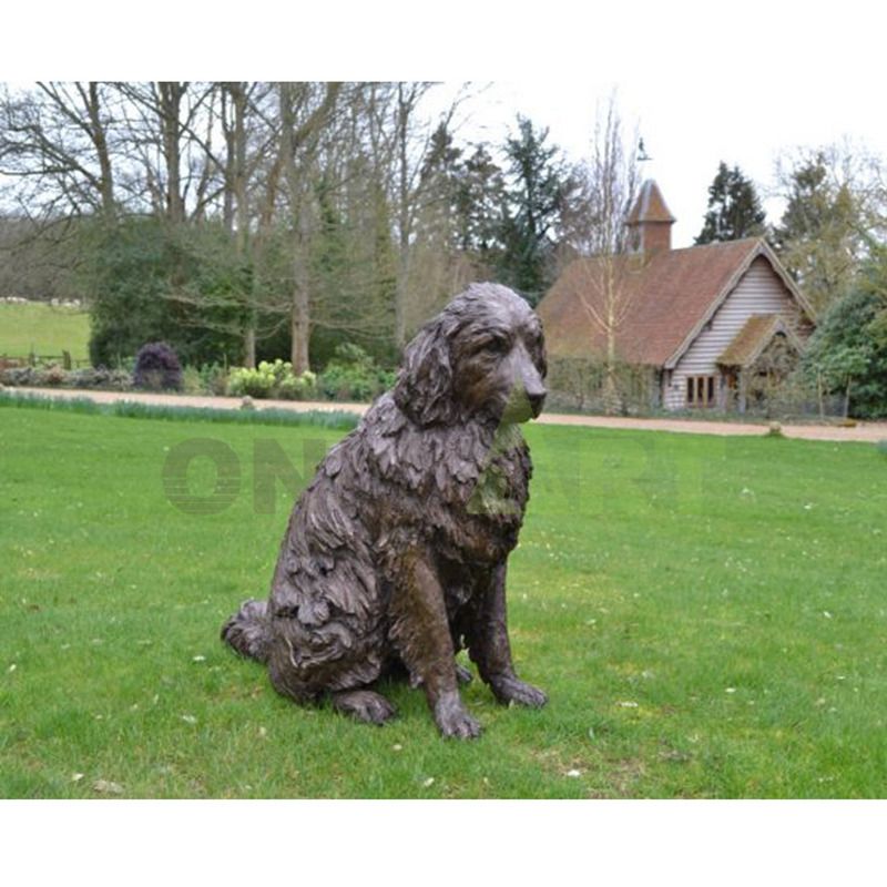 A sculpture of a golden retriever in front of the cottage on the lawn