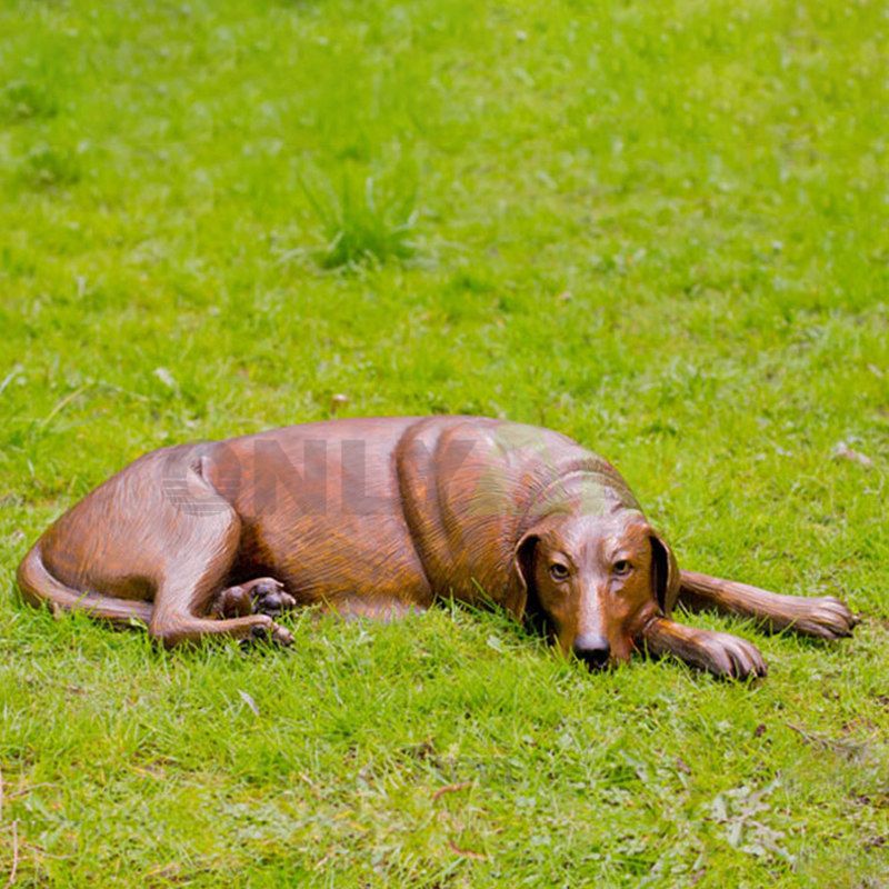 A bronze sculpture of a long-eared dog and her baby