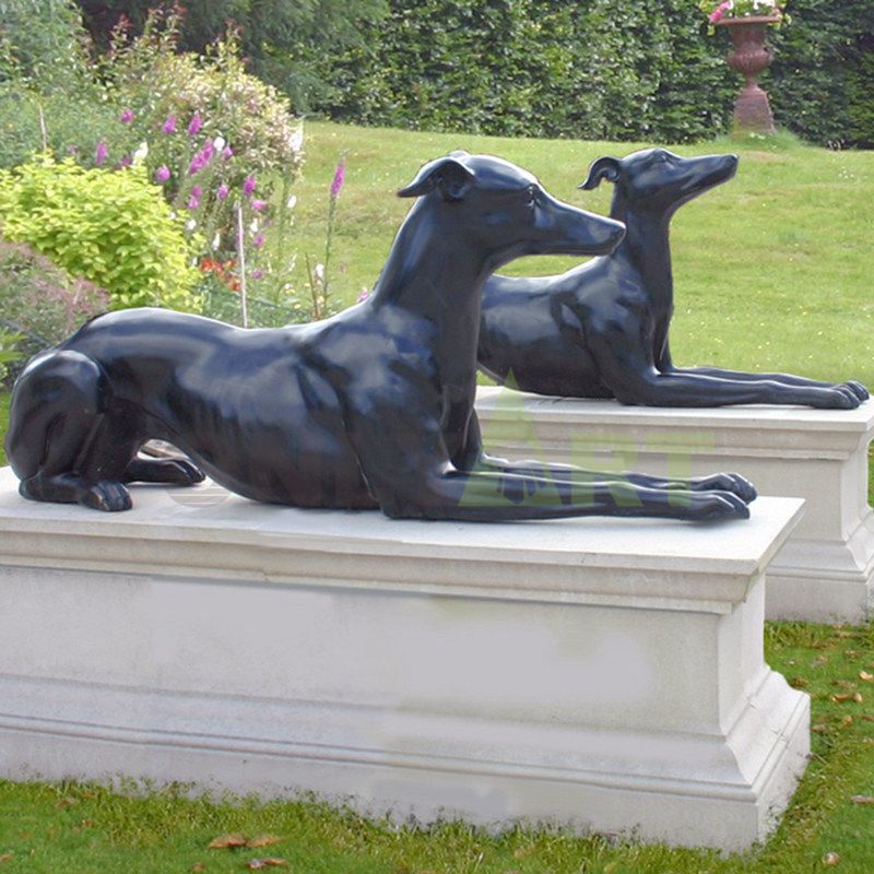 A garden or theme park is decorated with a life-size bronze dog sculpture
