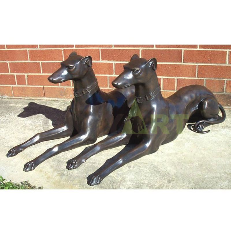 Two long-waisted dogs sitting in the sun