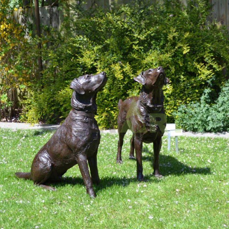 A lifelike bronze sculpture of a Doberman Dog in the jungle