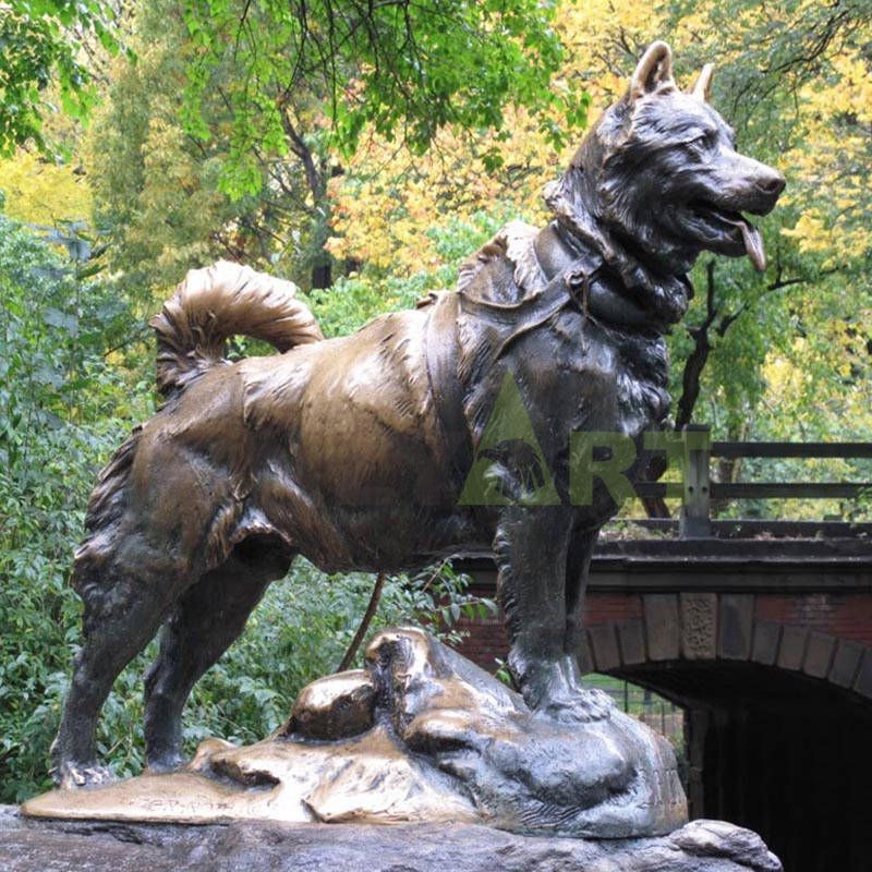 A lifelike bronze sculpture of a Doberman Dog in the jungle