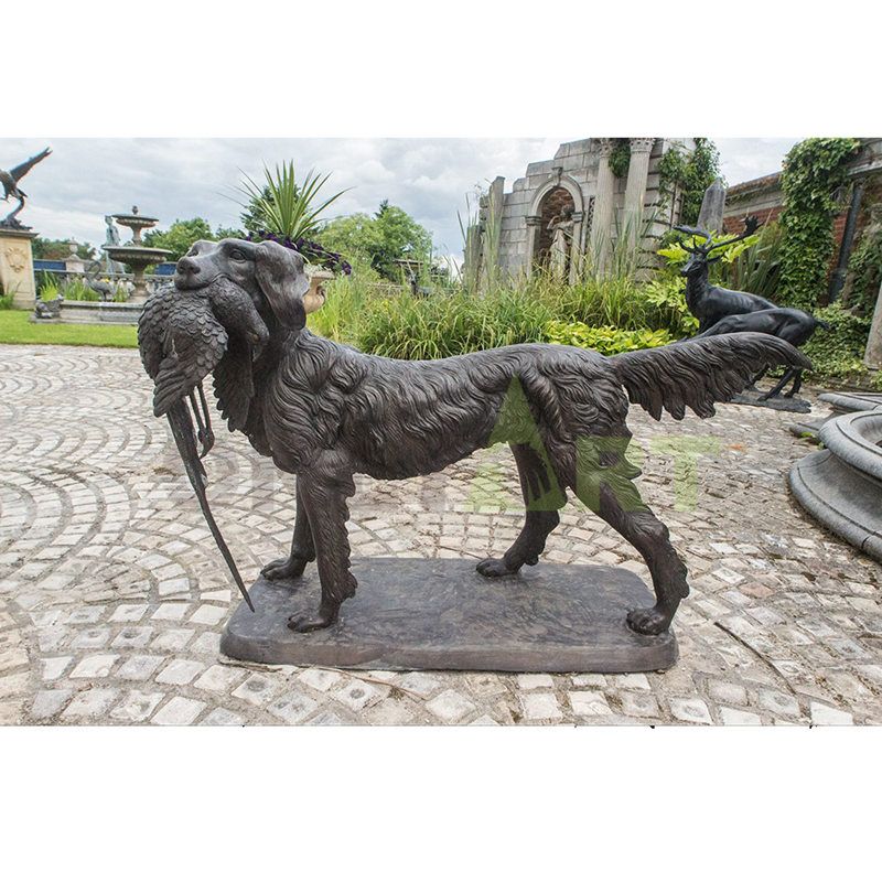 A bronze dog sculpture that captures a swallow