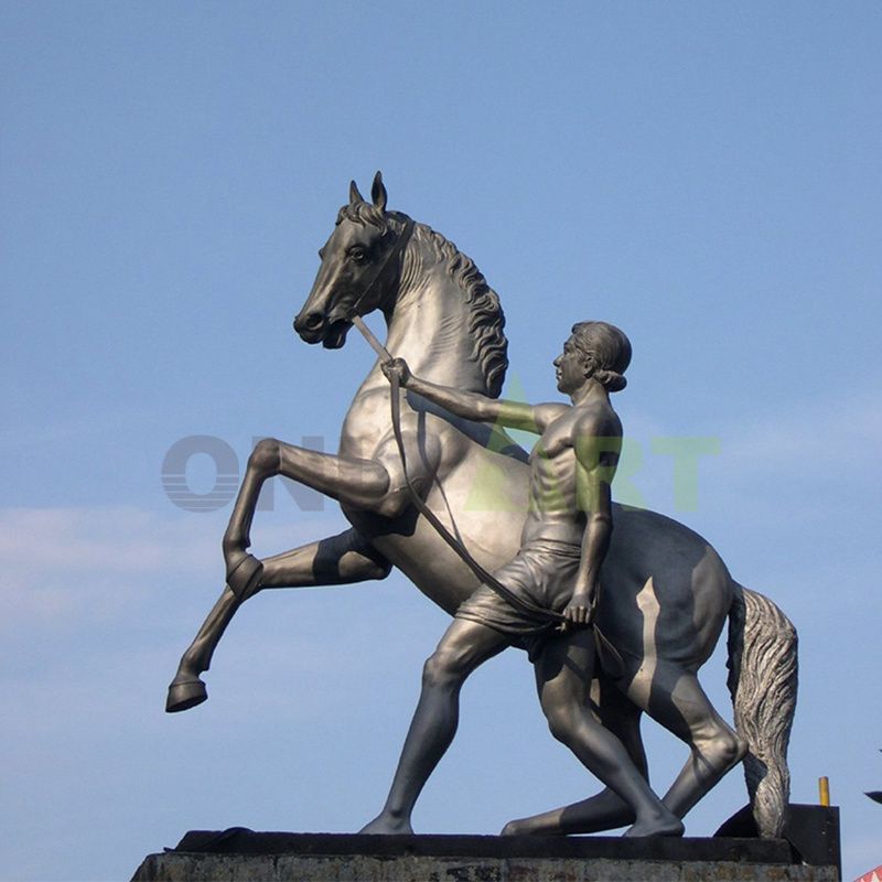 A bronze statue of three horses soaring into the air