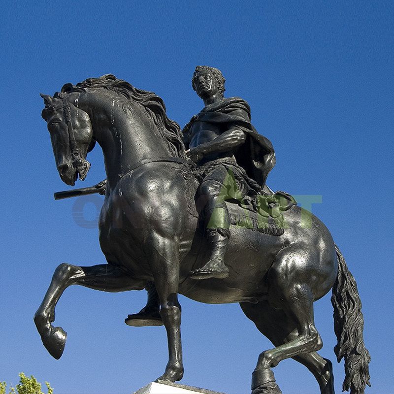 A bronze statue of three horses soaring into the air