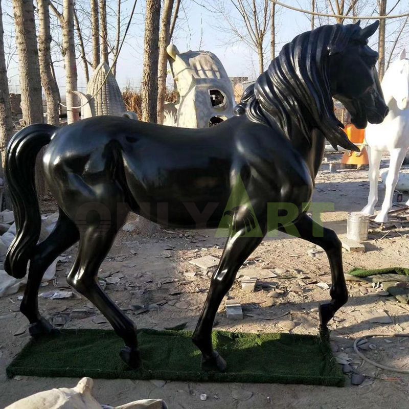 Frisian horse sculpture, with its head bowed and leaping