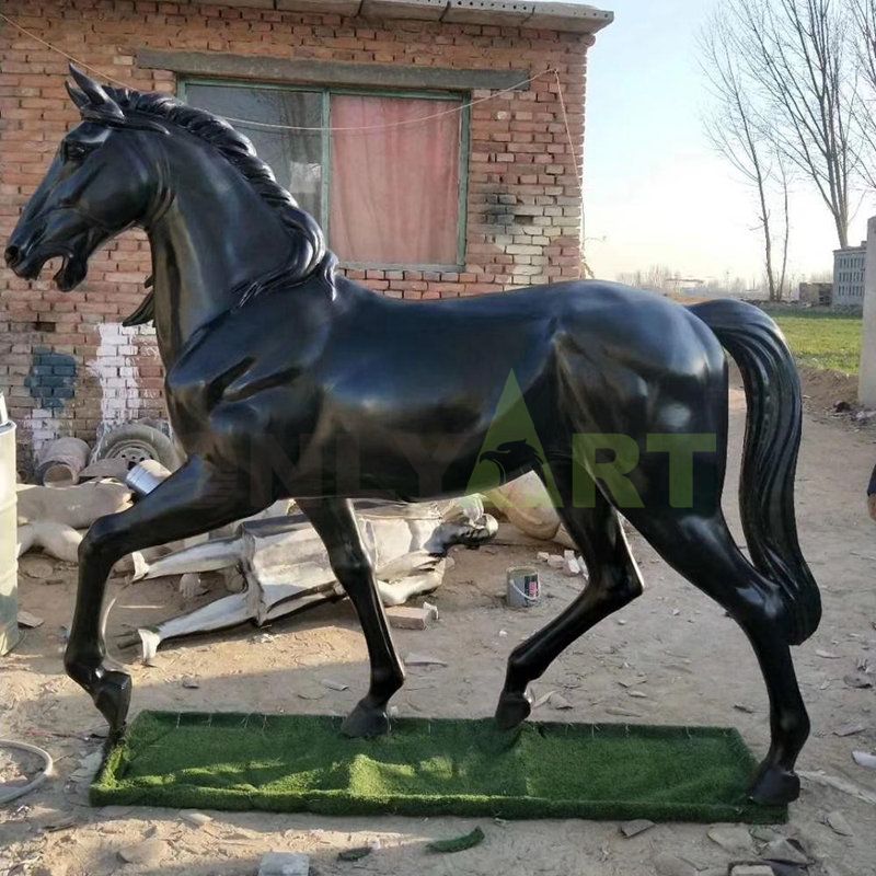 Frisian horse sculpture, with its head bowed and leaping