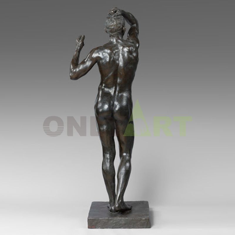 A bronze statue of a drunk man standing naked inside