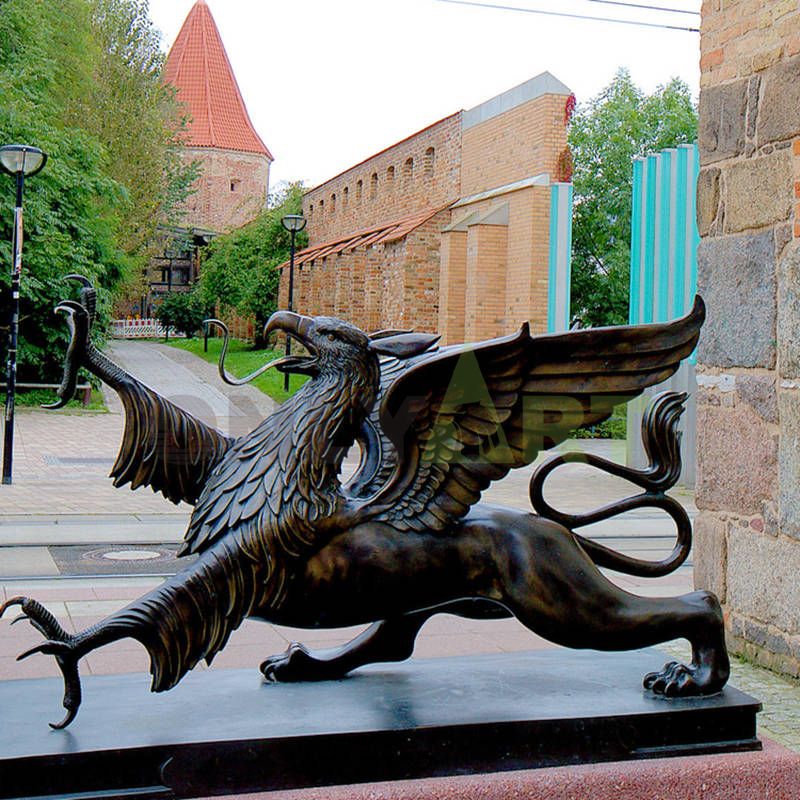 A sculpture of a gargoyle with the head of an eagle and the feet of a lion