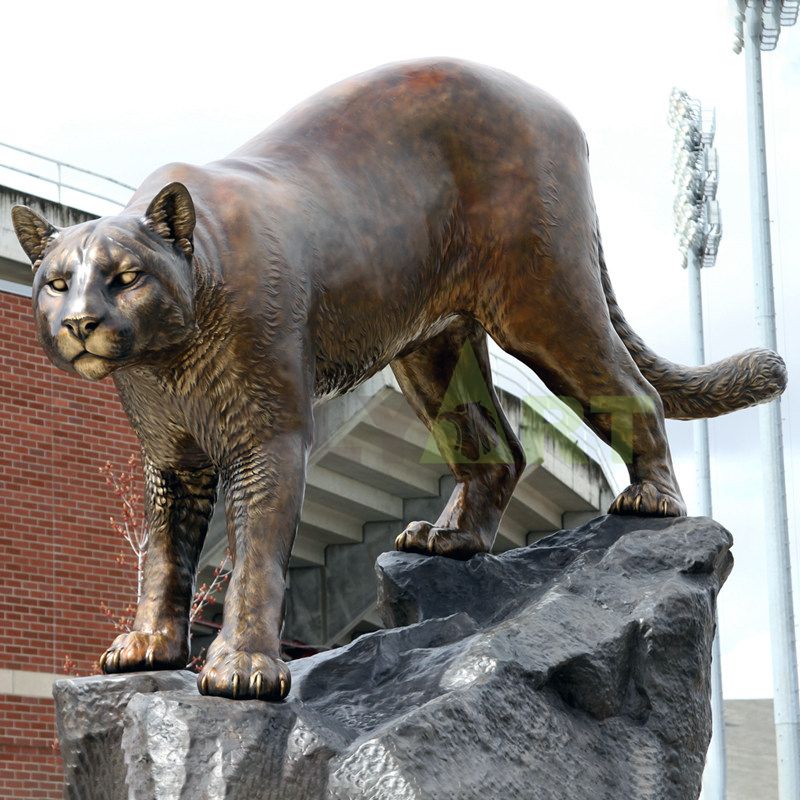 A custom-made bronze statue of a leopard that stands menacing on a rock