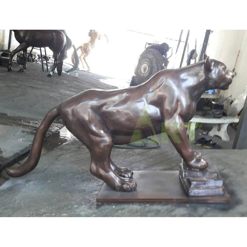 A custom-made bronze statue of a leopard that stands menacing on a rock