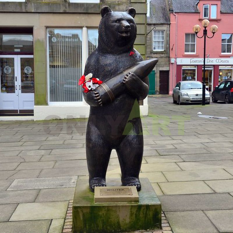 The bear stands with a bronze missile in his arms