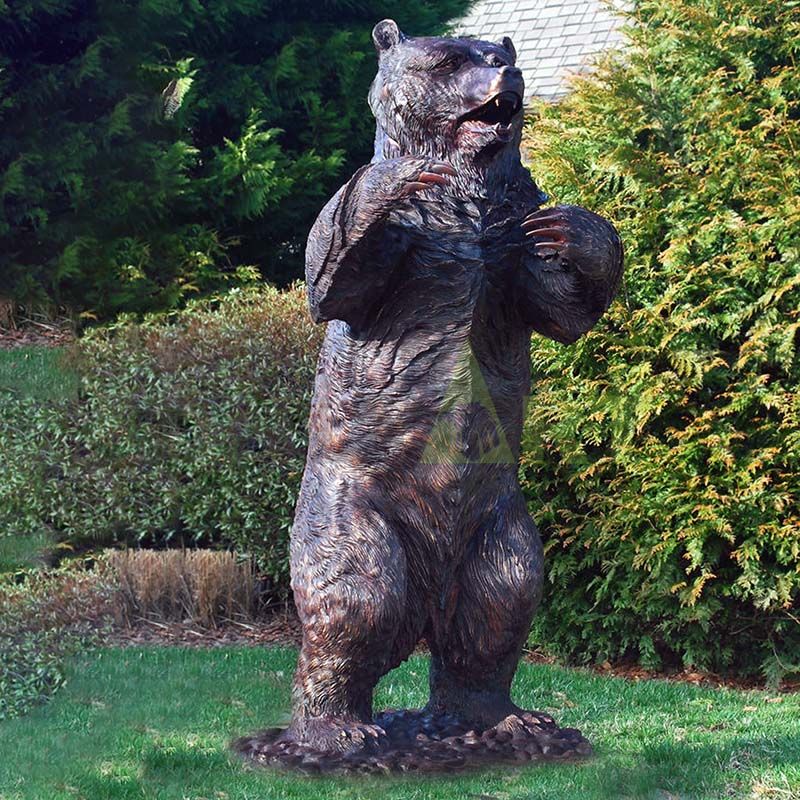 Bronze bear sculpture, panda holding a stone