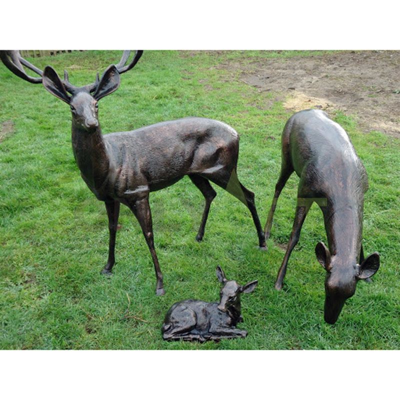 A family of three elk on the meadow. Bronze sculpture