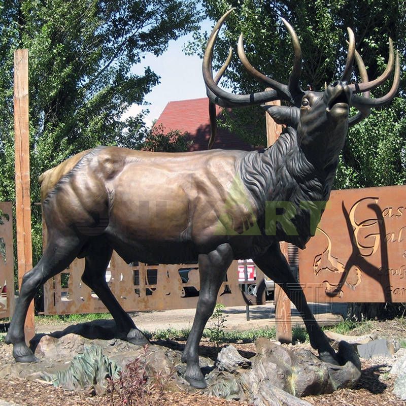 A family of three elk on the meadow. Bronze sculpture