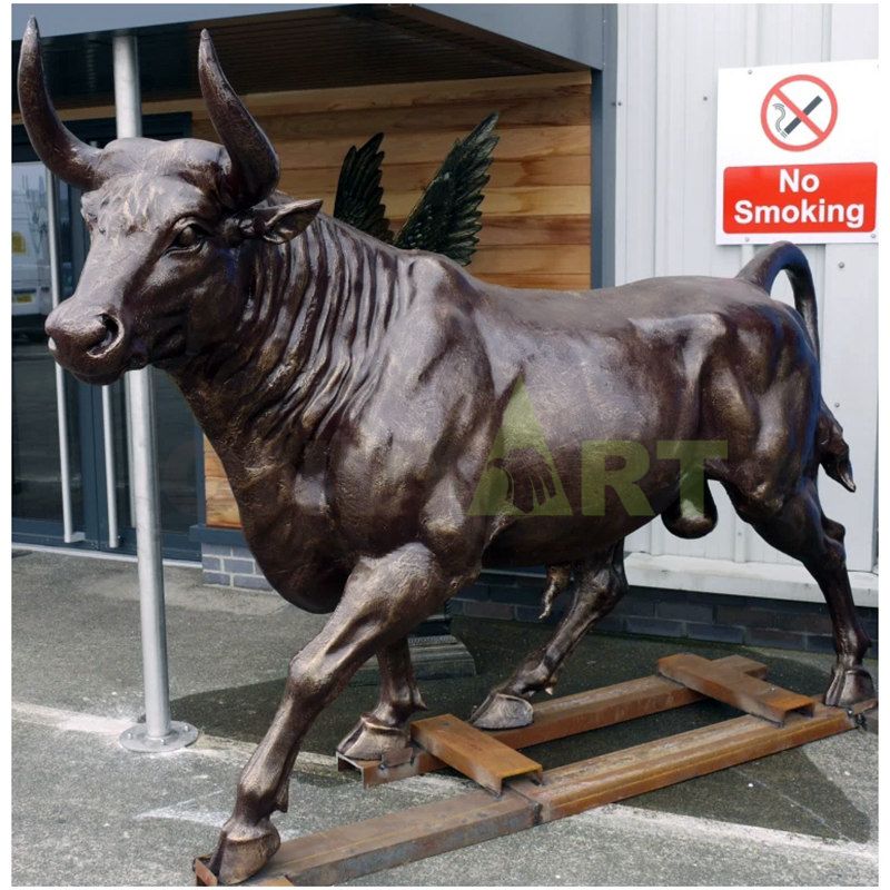 Decorative bronze bull sculpture beside the park lake