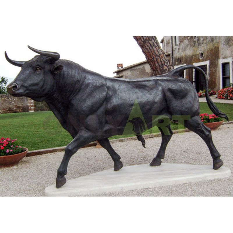 Decorative bronze bull sculpture beside the park lake