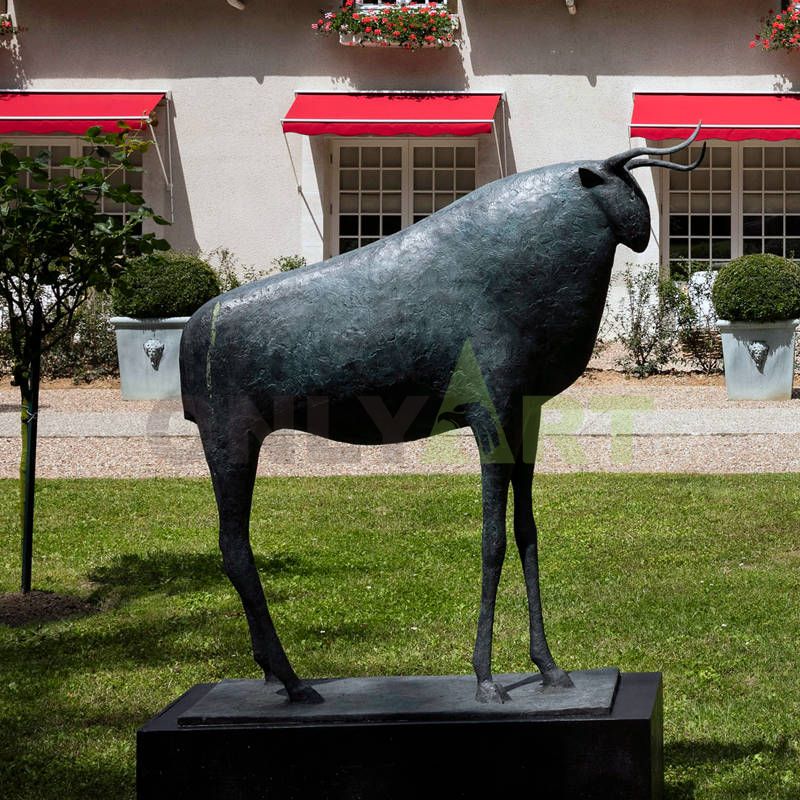 An abstract sculpture of a large exaggerated figure with a small head of bronze bull