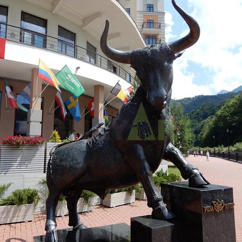 A sculpture of a beautiful woman and a bull wrapped around the back of an ox