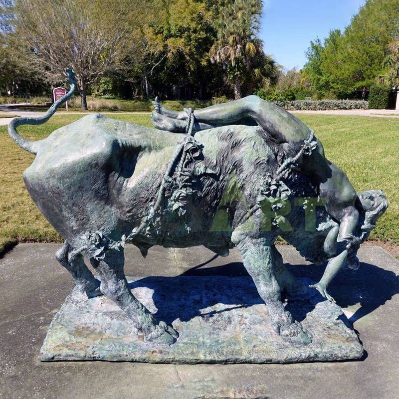 A sculpture of a beautiful woman and a bull wrapped around the back of an ox