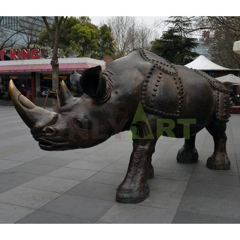 Rhinoceros bronze sculpture breaks through the fence