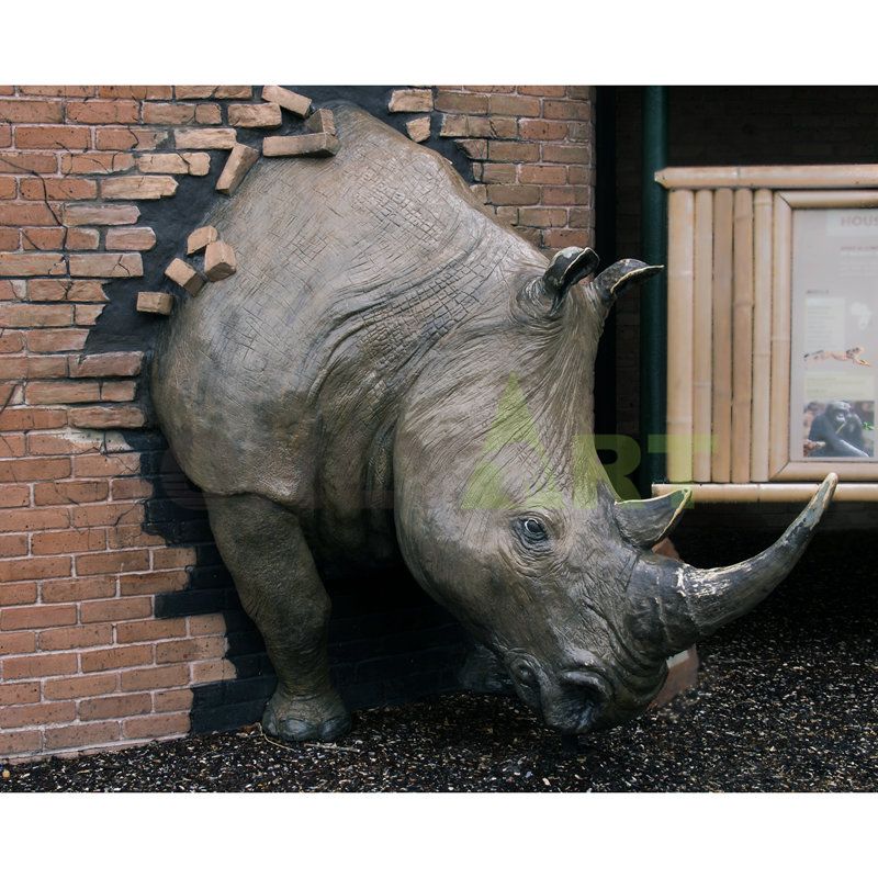 Rhinoceros bronze sculpture breaks through the fence