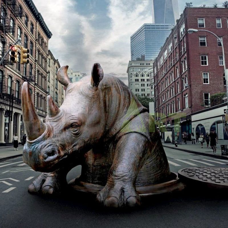 A sculpture of a rhinoceros beneath an animal couple