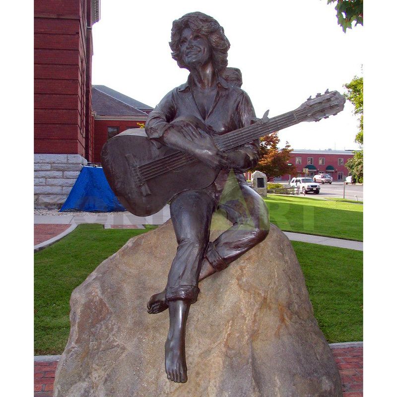 A woman musician sitting on a stone with short, gentle hair