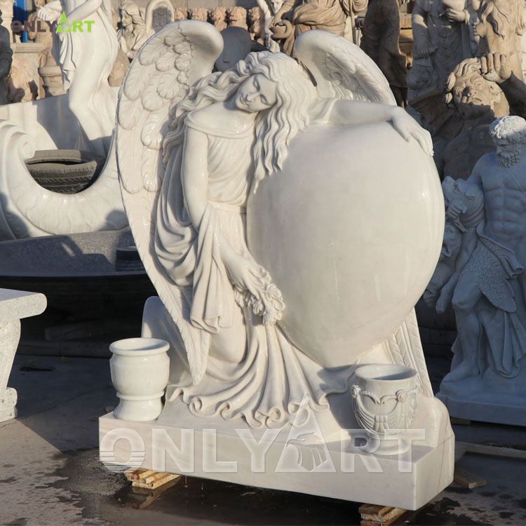 Hand-carved cemetery angel holding heart headstone monument